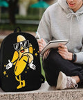 Cool Banana Style Backpack For Men And Women Go To Everyday Travel And Hiking 17 Inch Capacity With Durable 600D Oxford Fabric on ground next to person writing in notebook.
