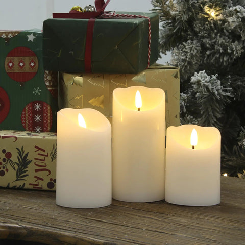Flameless Candles With Remote Set Of 3 Battery Operated Wax LED Flickering Pillar Candles White With Timer For Home Decor And Christmas Party Vibe For Any Occasion displayed on table with gifts and tree.