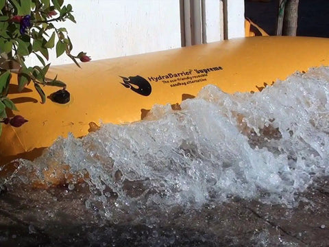 HydraBarrier Supreme 6 Foot Flood Barrier 12 Inch High Portable Water Diversion Tube stopping water near entrance