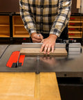 Beefy Precision Miter Gauge For Table Saws Featuring Heavy Duty Anodized Aluminum Construction, operator adjusting wood piece.