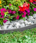 Heavy Duty No Dig Landscape Edging Kit 50 Foot Gray Plastic Edging bordering flower bed with rocks and flowers