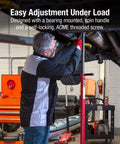 Sunex 6809A underhoist support stand in use under a vehicle; red steel stand with threaded screw and contoured saddle.
