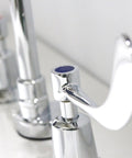 Close-up of polished chrome handle on Commander Gooseneck 8 Inch Widespread Lavatory Faucet Polished Chrome With Lead Free Brass Construction No Fuss 0.5 Gpm Flow Two Handle Lever Three Hole Installation