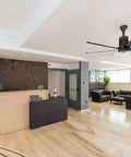 Massive 60 Inch Indoor Ceiling Fan With Direct Flush Mount And Sleek Black Finish enhancing a modern reception area.
