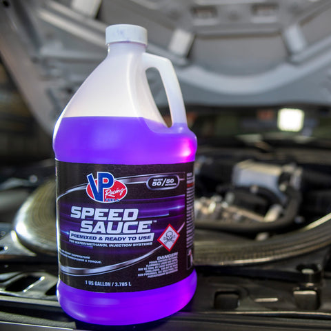 Speed Sauce Injection Fluid For Turbo, Supercharged And High-Compression Engines, 1 Gallon bottle, on car engine background