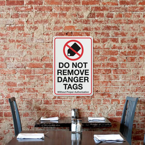 Industrial Grade Aluminum Safety Sign 8x12 Inch No Tampering Lockout Caution Plaque on brick wall near restaurant table