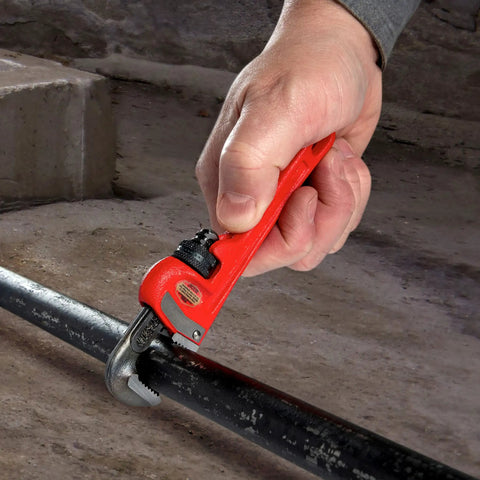 Using Heavy Duty 6 Inch Straight Pipe Wrench For Plumbing Projects With Serrated Steel Jaw And Cast Iron Handle Red Finish