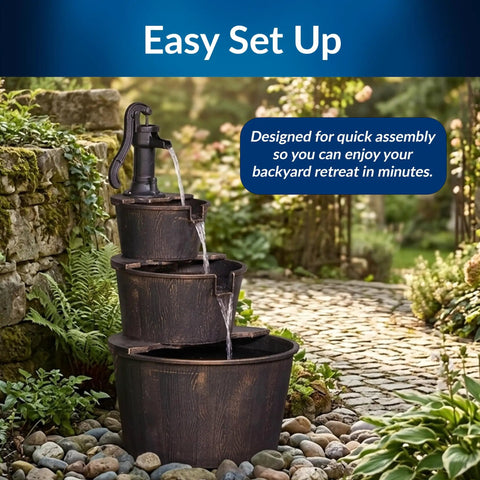 40 Inch Rustic Tiered Barrel Water Fountain For Outdoors with old-fashioned pump, three barrel tiers, in garden setting.