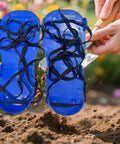 Heavy Duty Lawn Aerator Shoes with spikes and adjustable straps in use for outdoor yard maintenance, enhancing soil aeration