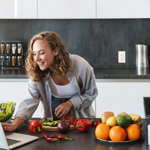 Woman cooking in kitchen with 15 Amp GFCI Outlets With LED Indicator And Self Test For Easy No Fuss Install Slim Duplex Receptacles.