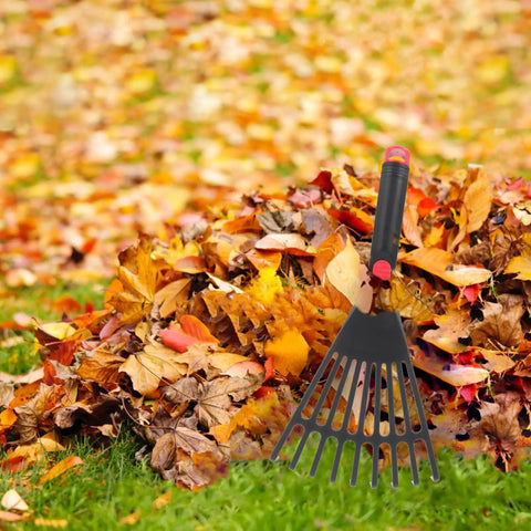 Two Piece Plastic Garden Pitchfork Rake Set With Leaf Grabber Claws For Lawn Cleanup in pile of autumn leaves