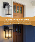 Set And Forget Dusk To Dawn Wall Mount Porch Light With Auto Photocell Sensor on exterior wall near a wooden door.