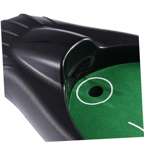 Close-up of the Golf Ball Retriever Auto Return System for Practice showing green putting surface and ball return slot.