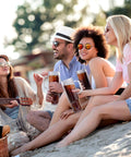 Group of friends enjoying drinks in 40 Oz Clear Double Wall Acrylic Tumbler With Handle And Straw Lid Reusable Water Bottle.