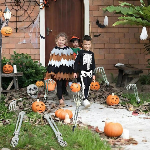 Halloween Skeleton Stakes Pack Of 5 Realistic Skull Arm And Leg Yard Props with kids in costumes on pathway
