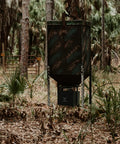 12 Volt Digital Power Control Unit For Deer Feeder With Universal Barrel Mounting Powder Coated Steel Housing in forest