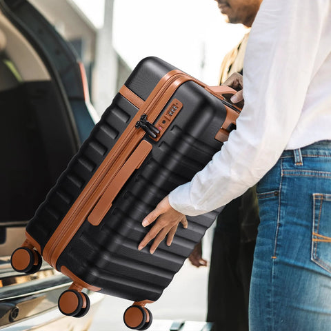 Carry-on luggage side view: black 20-inch hardside with brown trim, spinner wheels, built-in TSA lock