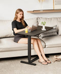 Woman using Adjustable Overbed Table With Wheels For Home Use, Extra Large 31.1 Inch By 15.3 Inch Bedside Tray Table, Black Finish