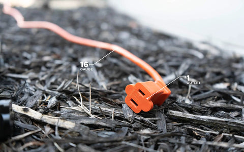 Bright Orange 50ft Outdoor Extension Cord 16/2 Two-Prong With SJTW Jacket for landscaping lying on mulch