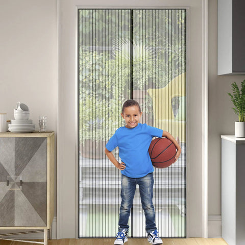 Boy holding basketball stands in doorway with Heavy Duty Magnetic Screen Door With Micro Mesh For Easy Hands Free Entry And Exit No Fuss