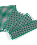 20 Piece Double Sided PCB Prototype Kit For DIY Projects Four Sizes Includes Five Boards Per Size Flexible Layout With No Predefined Routing Great For Arduino Prototyping And Electronics Nerds, showing four green FR4 boards in multiple sizes.
