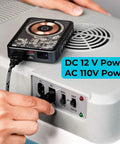 Massive 30L Electric Travel Cooler For Cars And Rvs 12V DC Portable Refrigerator connected to 220V power outlet.