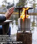 Mesa XL Heat Deflector With 3 Detachable Legs For Fire Pit captures warmth outdoors, stainless steel setup by the lake.