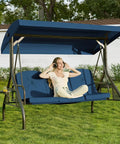Person relaxing on Three-Seat Outdoor Porch Swing with Adjustable Canopy and Stand, 800-Lb Capacity, Blue for Backyard Lounging