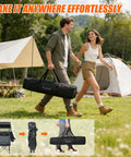 Two people carrying Heavy Duty Camping Chair With Canopy Shade And Umbrella Cup Holder in a portable bag through a campsite