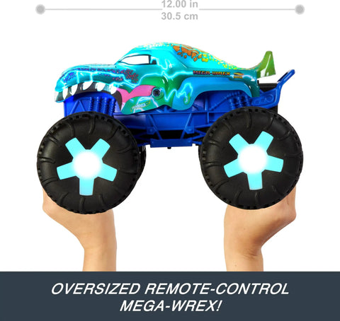 Hands holding Mega-Wrex 1:15 Scale RC Monster Truck with Lights and Sounds, showcasing oversized wheels and vibrant design.