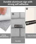 Two Pack Unisex Bathroom Signs For Doors Or Walls, Heavy Duty Metal Signs With Super Strong Adhesive, Easy Install, in use on grey wall