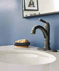 Westchester Single Hole Bathroom Faucet in oil rubbed bronze with ceramic disc technology on white counter, deck plate visible