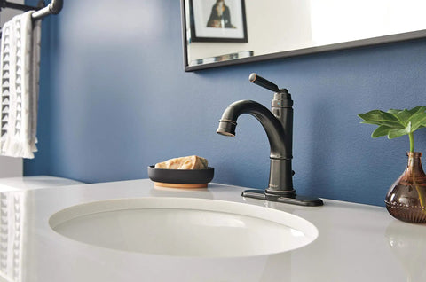 Westchester Single Hole Bathroom Faucet in oil rubbed bronze with ceramic disc technology on white counter, deck plate visible