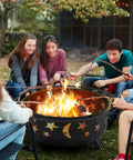 Round 30 Inch Fire Pit For Outdoor Wood Burning With Spark Screen And Poker Celestial Stars And Moon Cutouts Patio Backyard Bonfire Pit For Campouts And Picnics Easy To Use Night Vibes, people roasting marshmallows.