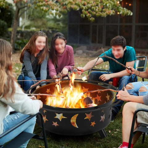 Round 30 Inch Fire Pit For Outdoor Wood Burning With Spark Screen And Poker Celestial Stars And Moon Cutouts Patio Backyard Bonfire Pit For Campouts And Picnics Easy To Use Night Vibes, people roasting marshmallows.