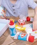 Child playing with Get Well First Aid Kit Play Set For Kids With 25 Realistic Medical Tools, including bandages and splint.