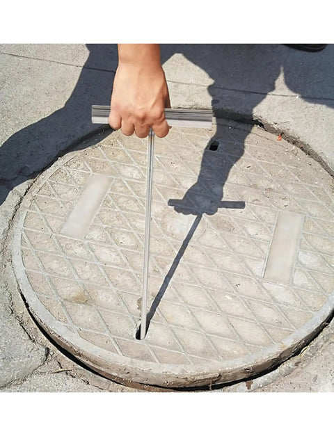 Person using Heavy Duty Stainless Steel T Hook Drain Grabber For Manhole Covers And Heavy Grates Built Like A Tank to lift a manhole cover.