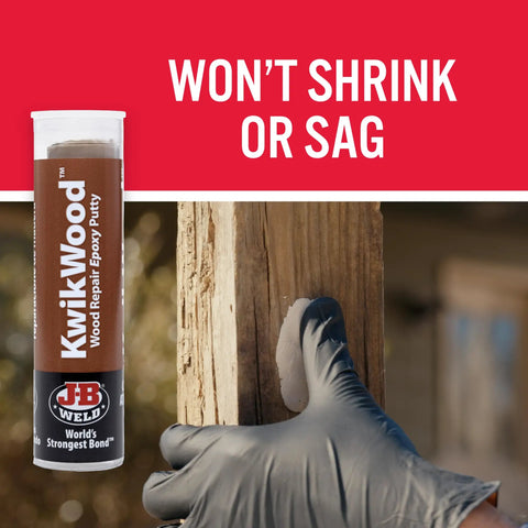 KwikWood Wood Repair Epoxy Putty Stick Tan 1 Oz Hand Mixable Two Part Repair Compound in use on damaged wooden surface