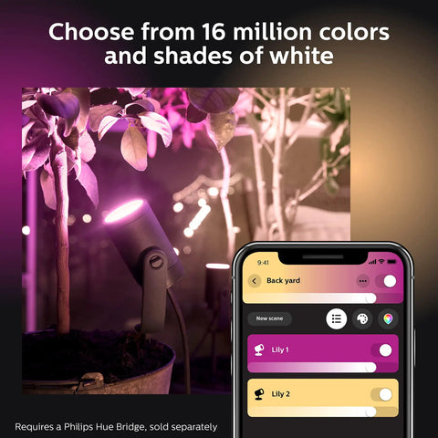 Lily Outdoor Smart Spotlight Base Kit Three Pack illuminating pink light on plants, controlled via app, Hue Bridge required.