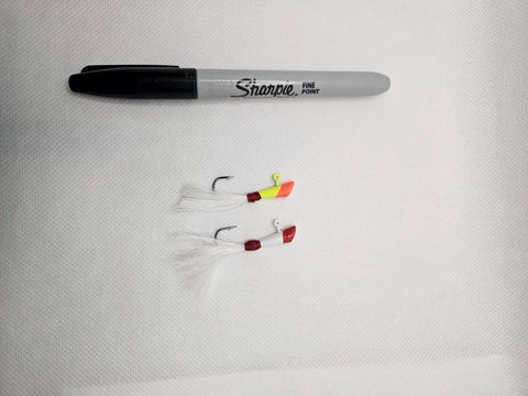 Two shad darts fishing lures with bucktail next to a Sharpie for scale, part of the Shad Darts Fishing Lures Kit 25 Pack With One Eighth Oz Jig Heads And Bucktail Assorted 5 Colors Perfect For Crappie American Shad Bass Walleye Panfish Realistic Swimming Action And Bright Paint.