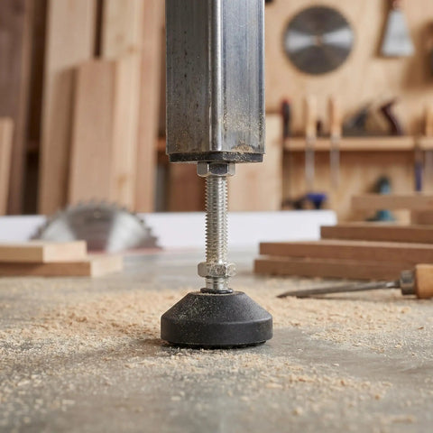 Close-up of Six Pack Adjustable Furniture Feet With M10x50mm Universal Thread on tile floor in workshop setting.