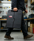 Person carrying All-In-One 140-Piece Home Tool Set For DIY And Home Repairs With Organized Storage Case in a workshop