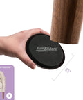 Hand holding Medium Round Reusable Carpet Furniture Sliders Set Of Sixteen Three And A Half Inch Anti Slip Moving Pads