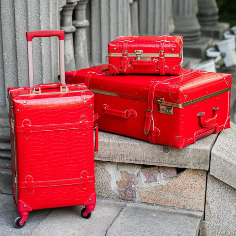 Vintage Inspired 3-Piece Luggage Set With Hardside Red Crocodile-Embossed Finish displayed on stone steps