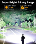Rechargeable 2,000,000 Lumen Spotlight Flashlight With COB Light illuminating a road and trees in dark