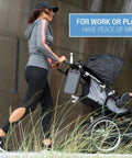 Woman walking with stroller featuring safebox portable safe with 3 digit resettable combination lock, slash resistant material, attached