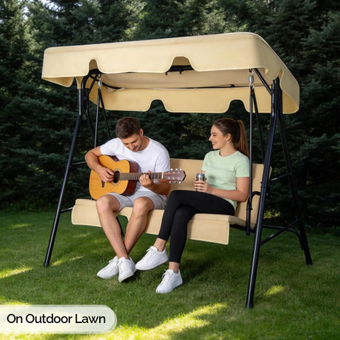 Outdoor Porch Swing With Adjustable Canopy And Heavy Duty Stand, beige cushions, two people seated, in garden setting