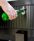 Close-up of hand opening a bottle using the opener on the 120-Qt Rolling Ice Chest Cooler Cart with Wheels, black.