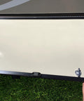 Magnetic RV Door Holder Set White Five Pairs For Secure Trailer Door Closure with hand holding exterior door on grass