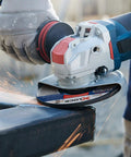 Street Tough 4.5 Inch Angle Grinder Featuring X Lock Tool Free Disc Swap Mount in action, grinding metal with ergonomic grip.